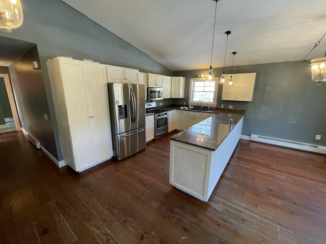 kitchen featuring pendant lighting, sink, baseboard heating, appliances with stainless steel finishes, and kitchen peninsula