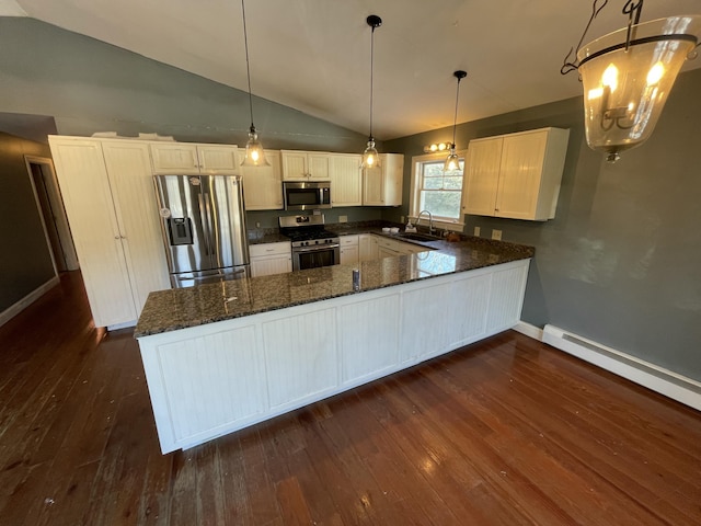 kitchen featuring pendant lighting, white cabinetry, sink, kitchen peninsula, and stainless steel appliances