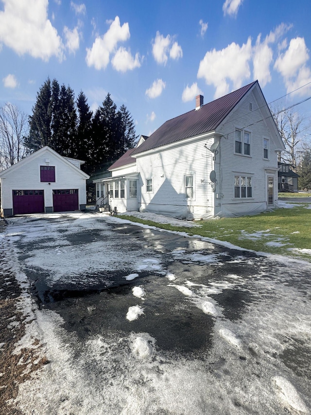 view of home's exterior featuring a garage and an outdoor structure