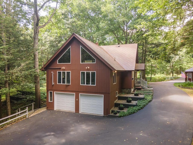 417 Middle Rd, Falmouth, ME 04105 - view of side of home with a garage, aphalt driveway, fence, and a shingled roof