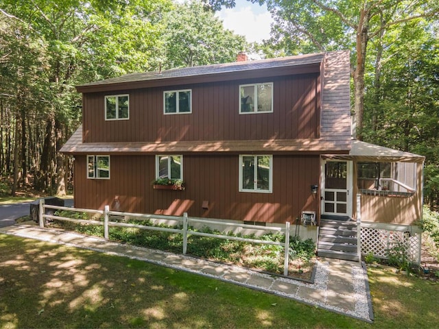 417 Middle Rd, Falmouth, ME 04105 - view of front of house featuring roof with shingles, a chimney, and fence