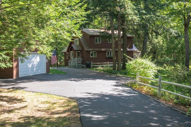 417 Middle Rd, Falmouth, ME 04105 - rustic home with a garage, driveway, fence, and an outbuilding