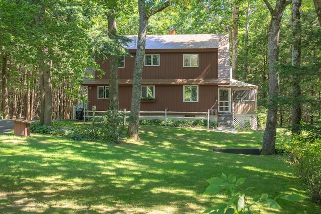 417 Middle Rd, Falmouth, ME 04105 - rear view of house with a yard, a sunroom, and a chimney