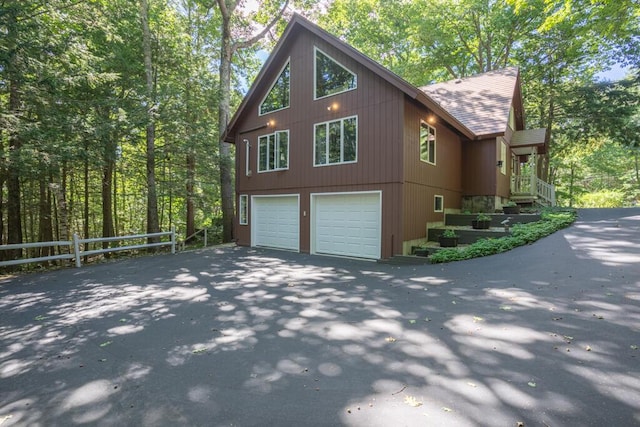 417 Middle Rd, Falmouth, ME 04105 - view of property exterior featuring fence, an attached garage, a shingled roof, and driveway