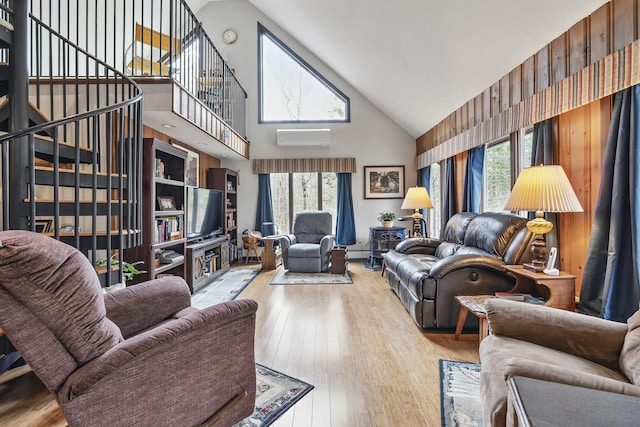417 Middle Rd, Falmouth, ME 04105 - living room with high vaulted ceiling, hardwood / wood-style flooring, and a wall mounted air conditioner