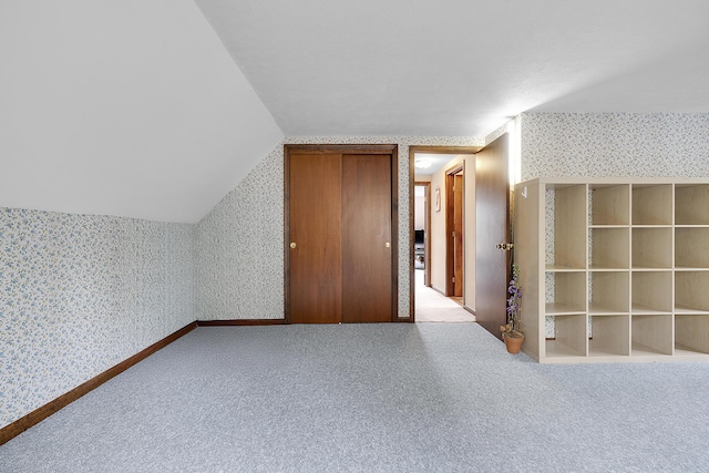417 Middle Rd, Falmouth, ME 04105 - additional living space with wallpapered walls, vaulted ceiling, carpet flooring, and baseboards