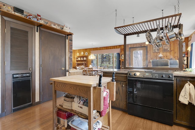 417 Middle Rd, Falmouth, ME 04105 - kitchen featuring wood walls, black electric range, and light wood-type flooring