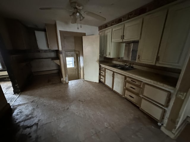 kitchen featuring sink, cream cabinetry, and ceiling fan