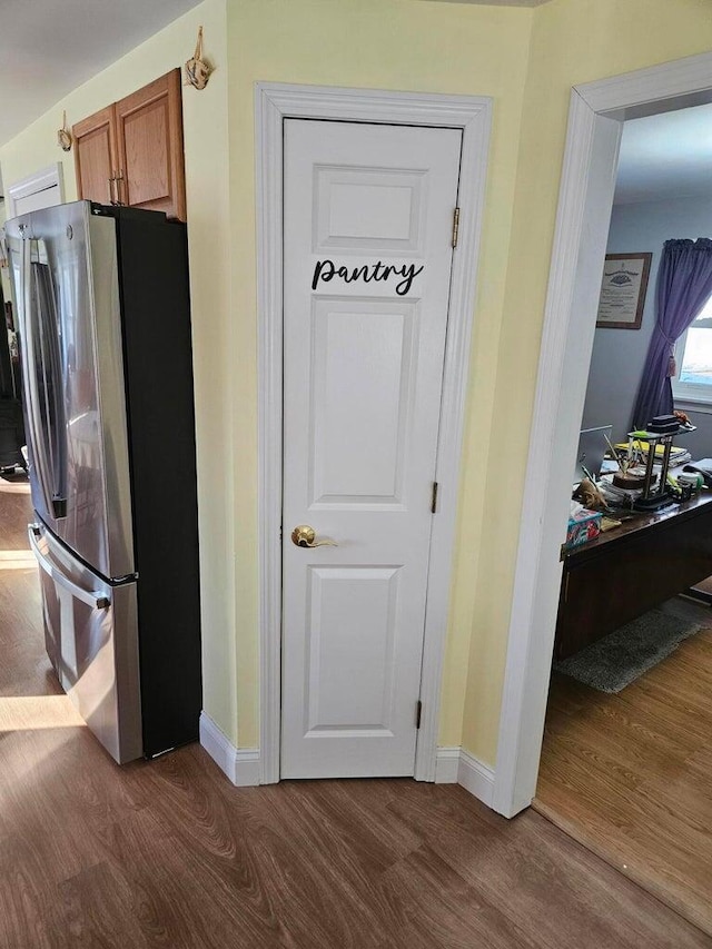 kitchen with stainless steel refrigerator and dark wood-type flooring