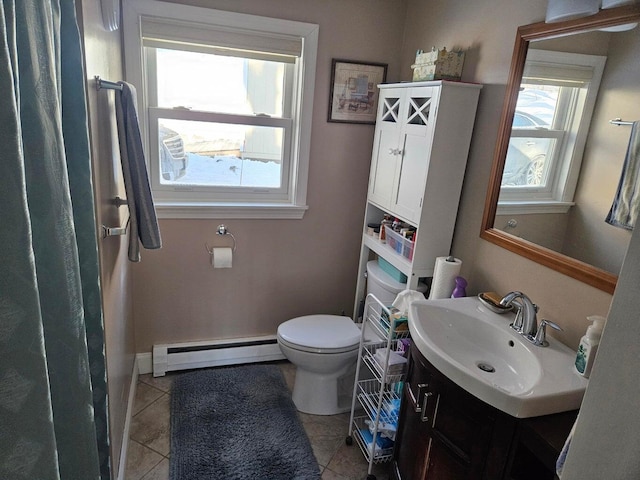 bathroom with a baseboard radiator, vanity, toilet, and tile patterned floors