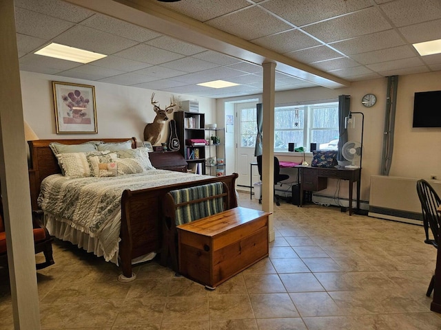 bedroom with a paneled ceiling and light tile patterned floors