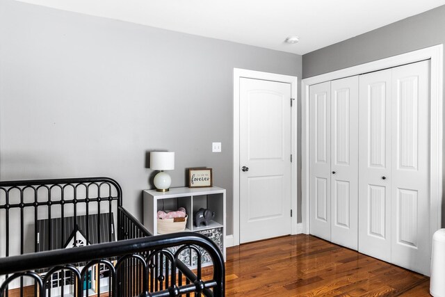 bedroom featuring dark hardwood / wood-style floors and a closet