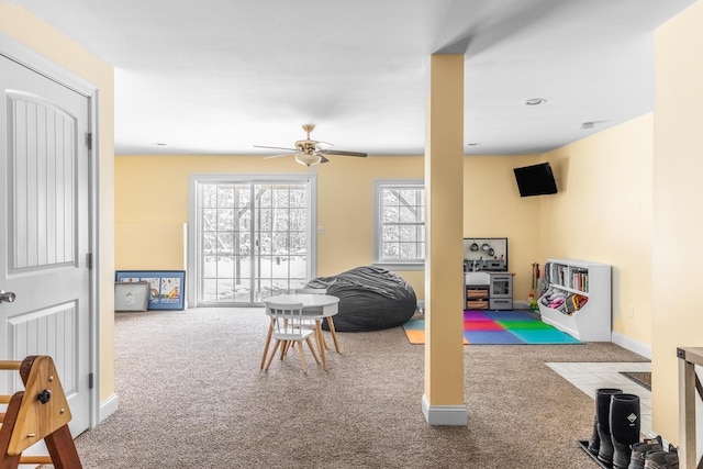 recreation room featuring light colored carpet and ceiling fan