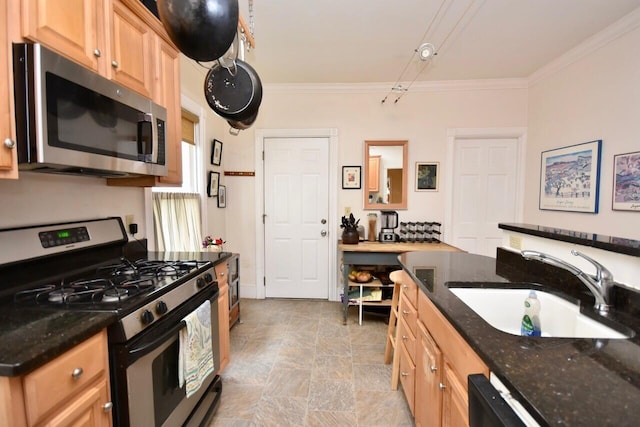 kitchen featuring stainless steel appliances, crown molding, sink, and dark stone counters