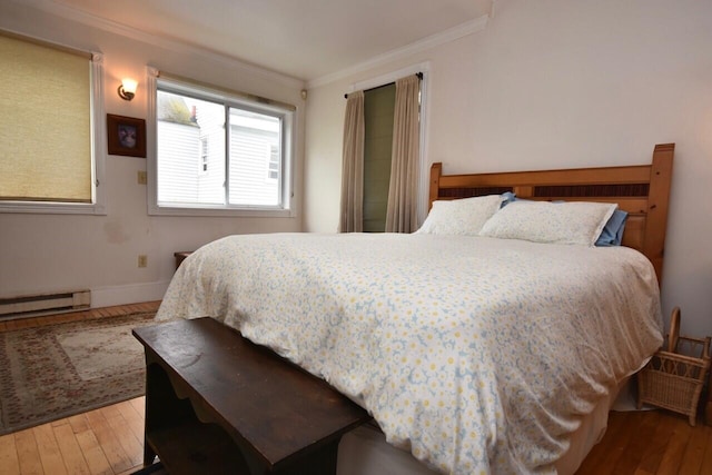 bedroom with hardwood / wood-style flooring, a baseboard radiator, and crown molding