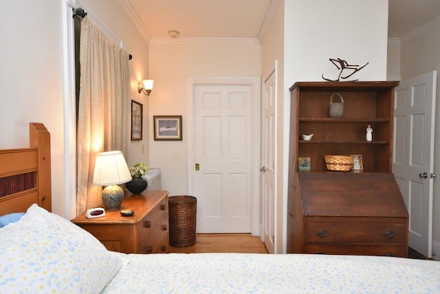 bedroom with crown molding and wood-type flooring