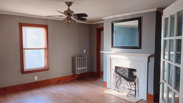 7 Hidden Meadow Ln, Dixfield, ME 04224 - unfurnished living room featuring a ceiling fan, ornamental molding, wood finished floors, a brick fireplace, and heating unit