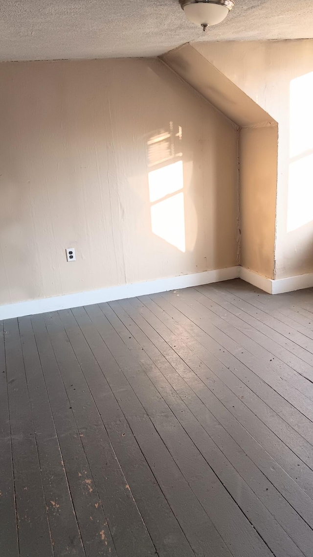7 Hidden Meadow Ln, Dixfield, ME 04224 - bonus room featuring a textured ceiling, hardwood / wood-style floors, and vaulted ceiling