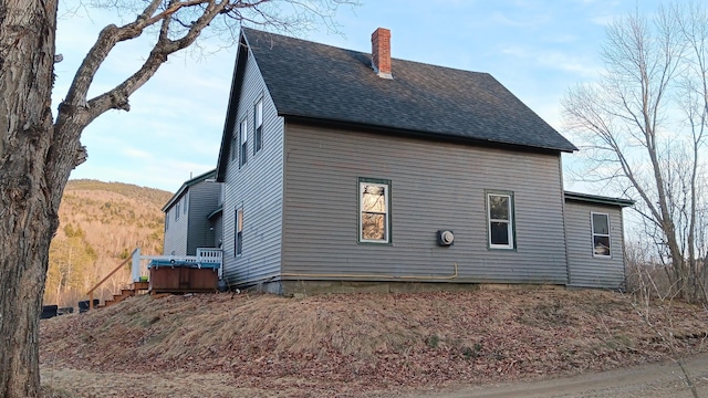7 Hidden Meadow Ln, Dixfield, ME 04224 - view of side of home with a mountain view, roof with shingles, and a chimney