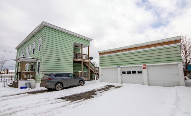 view of snowy exterior with a garage