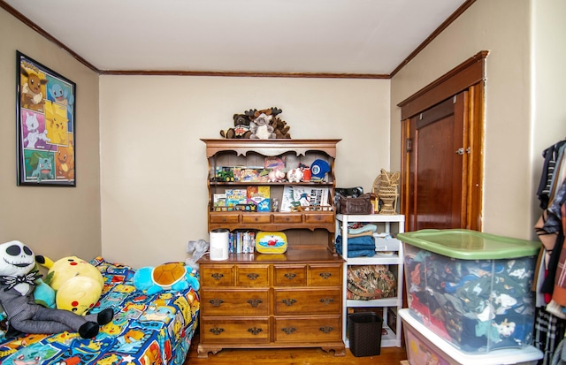 bedroom featuring crown molding and wood-type flooring