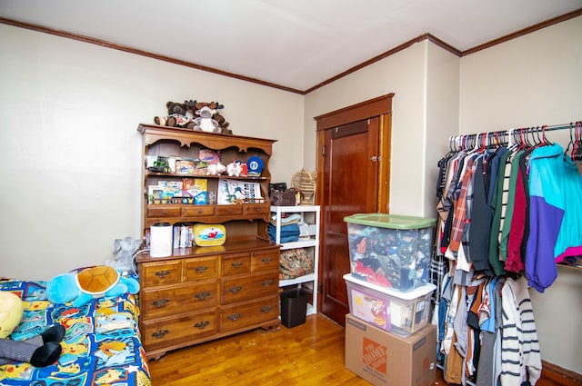 bedroom with light hardwood / wood-style flooring and ornamental molding