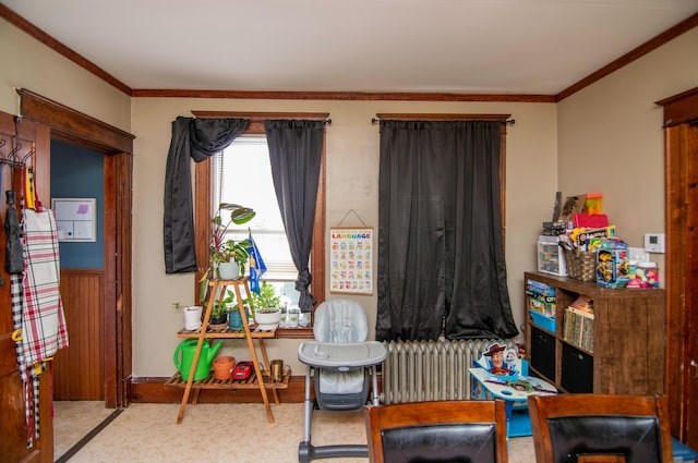 recreation room featuring light carpet, radiator, and crown molding