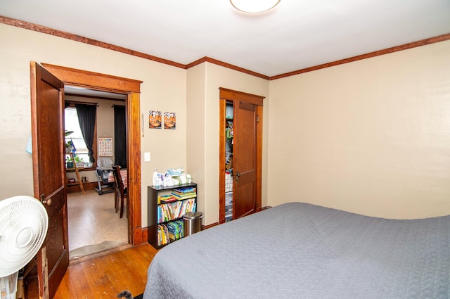 bedroom featuring hardwood / wood-style floors and ornamental molding