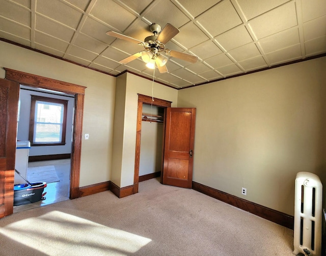 unfurnished bedroom with light carpet, a closet, and ceiling fan