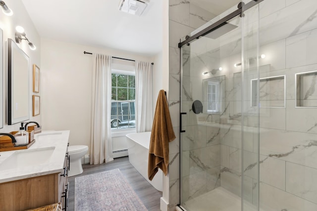 full bathroom featuring hardwood / wood-style flooring, a baseboard radiator, vanity, and plus walk in shower