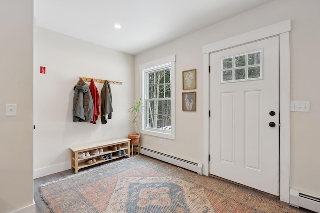 mudroom with a baseboard heating unit and hardwood / wood-style floors