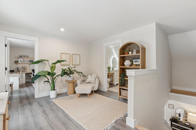 sitting room with hardwood / wood-style flooring