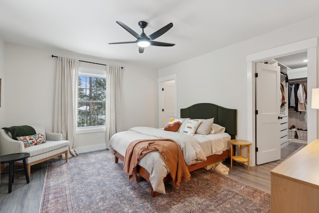 bedroom with dark hardwood / wood-style floors and ceiling fan