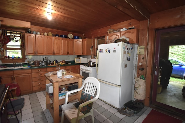 kitchen featuring white appliances, light tile patterned floors, and wooden ceiling