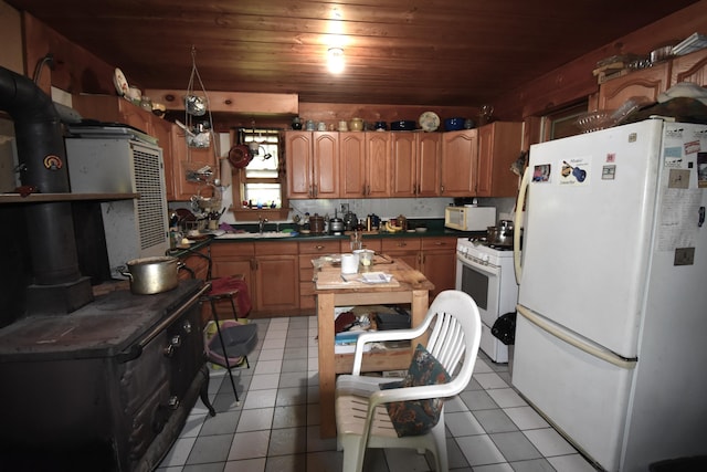 kitchen featuring light tile patterned flooring, wooden ceiling, and white appliances