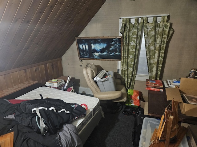 bedroom featuring wooden walls, vaulted ceiling, and wooden ceiling