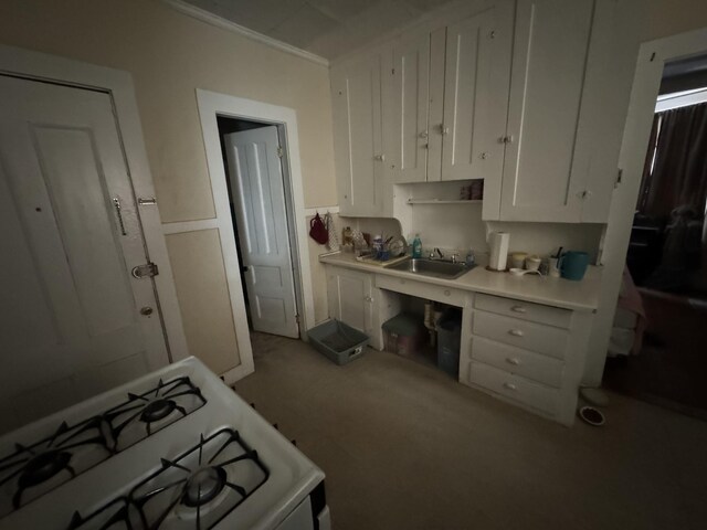 52 Hampshire St, Auburn, ME 04210 - kitchen featuring white cabinetry, sink, white range with gas stovetop, and ornamental molding