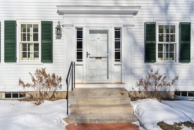 view of snow covered property entrance