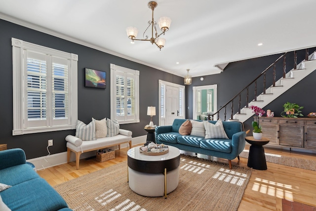 living room with ornamental molding, hardwood / wood-style floors, and an inviting chandelier