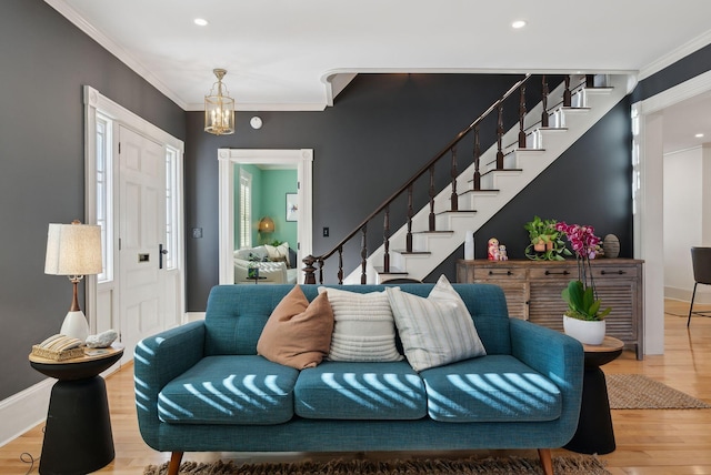 living room featuring hardwood / wood-style flooring and ornamental molding