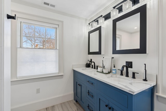 bathroom featuring vanity, hardwood / wood-style flooring, and ornamental molding