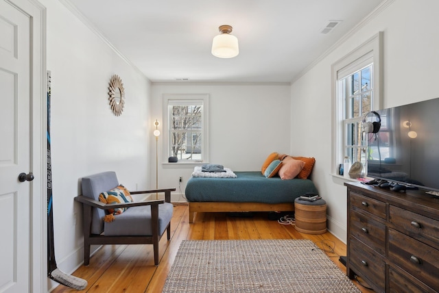 bedroom featuring light hardwood / wood-style flooring and ornamental molding