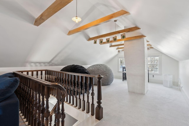 stairway with lofted ceiling with beams and carpet floors