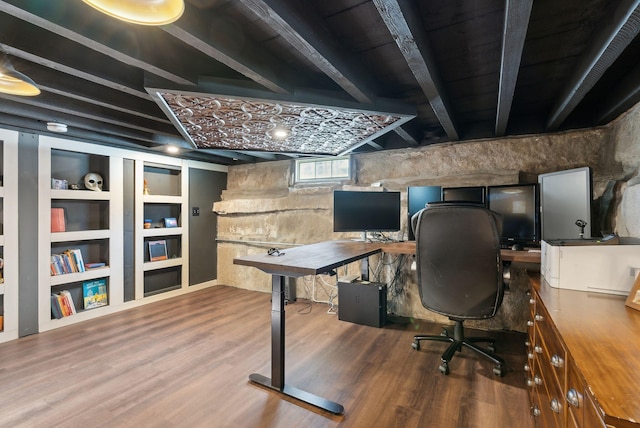 office space with built in shelves and wood-type flooring