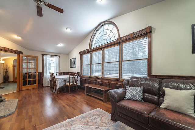 living room with dark wood-type flooring, ceiling fan, and lofted ceiling