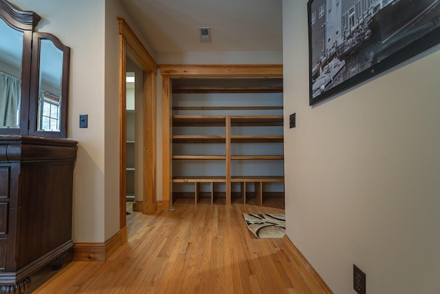 hallway with light hardwood / wood-style flooring