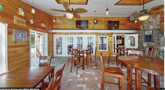 557 Coles Hill Rd, Wells, ME 04090 - dining space featuring a high ceiling, wood walls, ceiling fan, and french doors