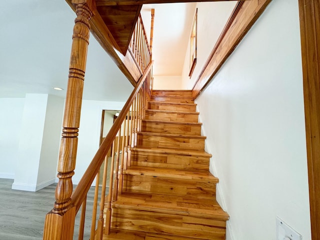 stairs featuring wood-type flooring