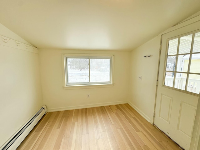 unfurnished room featuring light hardwood / wood-style flooring, a baseboard radiator, and lofted ceiling