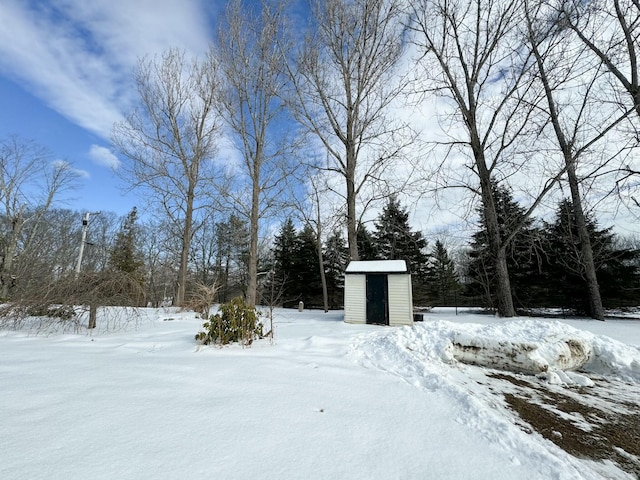 snowy yard with a storage unit